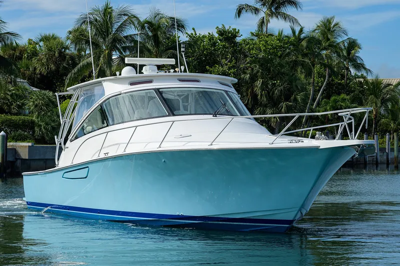 Galene Yacht Photos Pics 2013 Viking 42 Open yacht cruising on calm waters with lush greenery background.