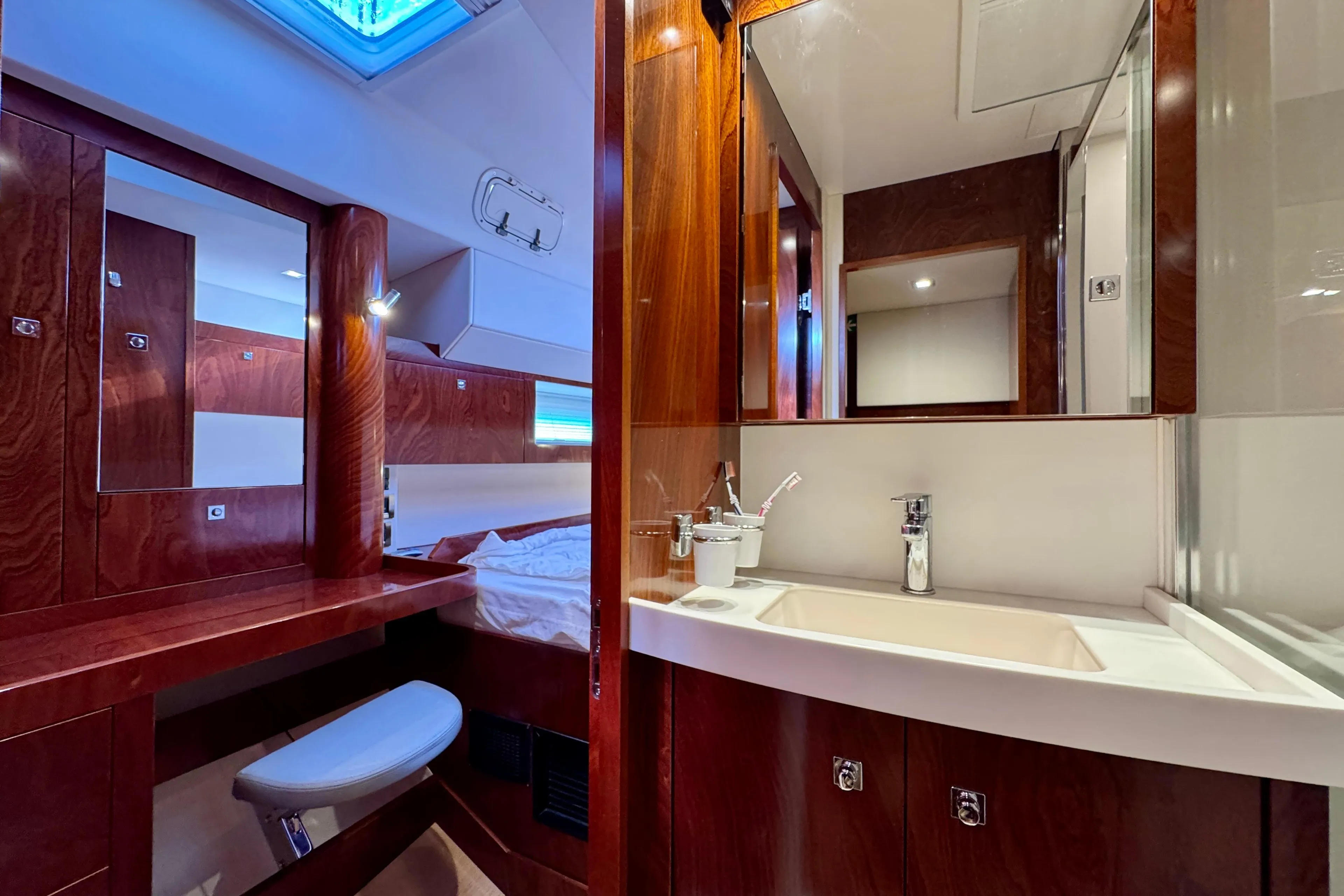 Luxurious Amel 55 yacht interior, featuring a modern bathroom and wooden cabinetry, 2015 model.