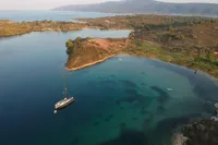 Aerial view of a Solaris 50 yacht anchored in a serene coastal bay, 2019.