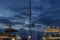 Sailboat Solaris 50, 2019 model, docked at night between yachts.