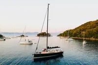 Sailing yacht Solaris 50, 2019 model, anchored in serene bay with surrounding boats.