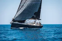 Sailing yacht Solaris 50, 2019 model, gliding on open sea with black sails.