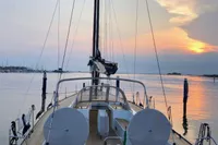 Sailing yacht Solaris 50, 2019 model, docked at sunset with calm waters.