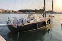 Luxurious 2019 Solaris 50 yacht docked at sunset in a serene marina.