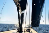Sailing on a 2019 Solaris 50 yacht, sunlit deck and open sea view.