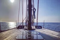Sailing on a 2019 Solaris 50 yacht with a serene ocean view at sunset.