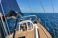 Sailing on a 2019 Solaris 50 yacht in open sea under clear blue skies.