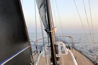 Sailing on a 2019 Solaris 50 yacht with sleek deck and calm sea view.