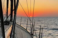 Sailing on Solaris 50 yacht at sunset, 2019, with ocean horizon view.