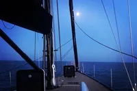 Sailing on a 2019 Solaris 50 yacht under a moonlit sky.
