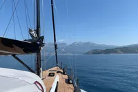 Sailing on a 2019 Solaris 50 yacht with scenic mountain views.