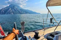 Sailing on a 2019 Solaris 50 yacht with mountain view and clear blue sea.