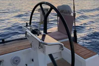 Steering wheel of 2019 Solaris 50 yacht at sunset on the ocean.