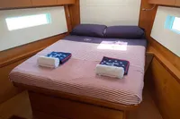 Luxurious cabin interior of 2019 Solaris 50 yacht with neatly arranged bed and towels.