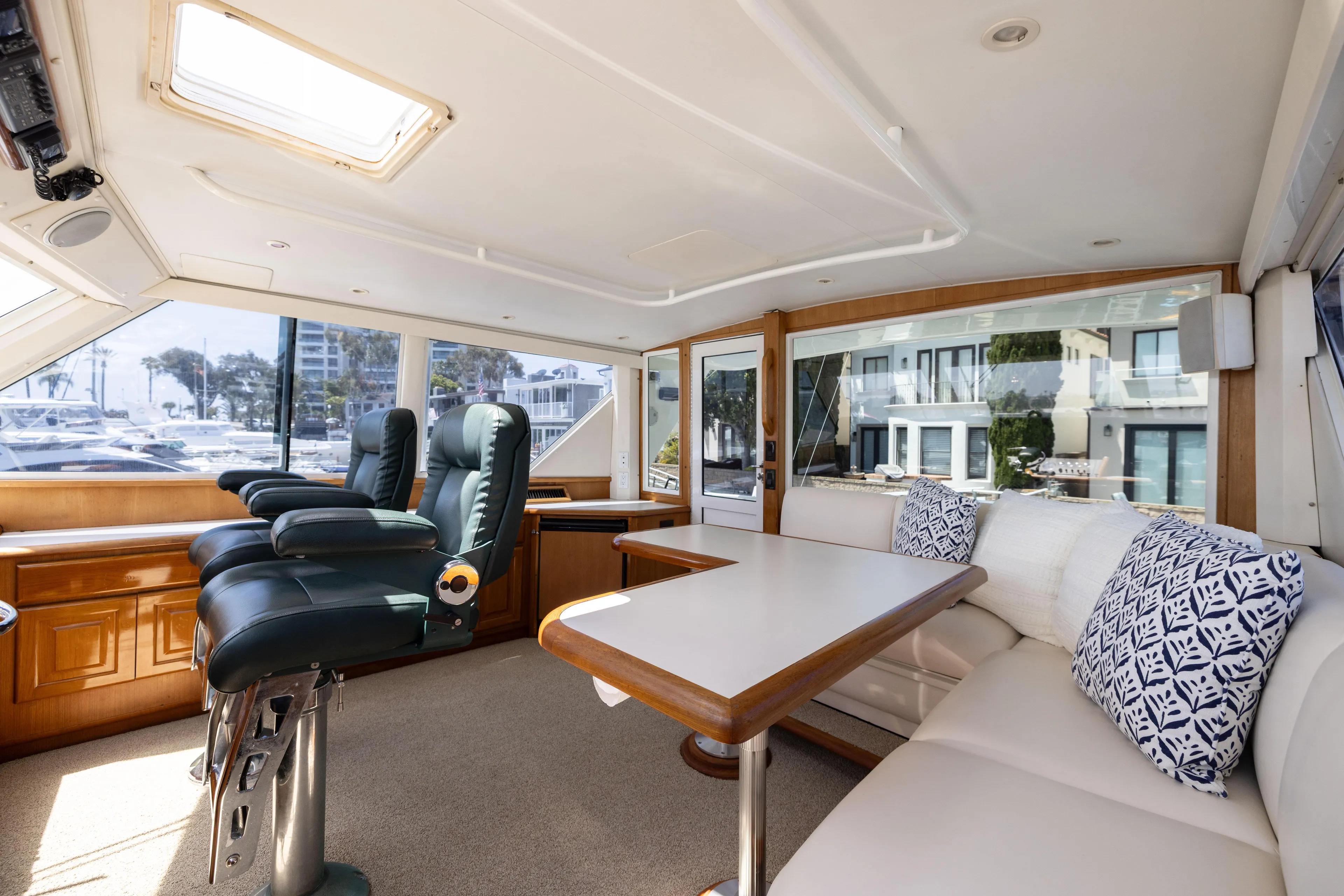 Fan Tail II Yacht Photos Pics Luxurious interior of a 1995 Viking Enclosed Bridge yacht with plush seating and scenic windows.