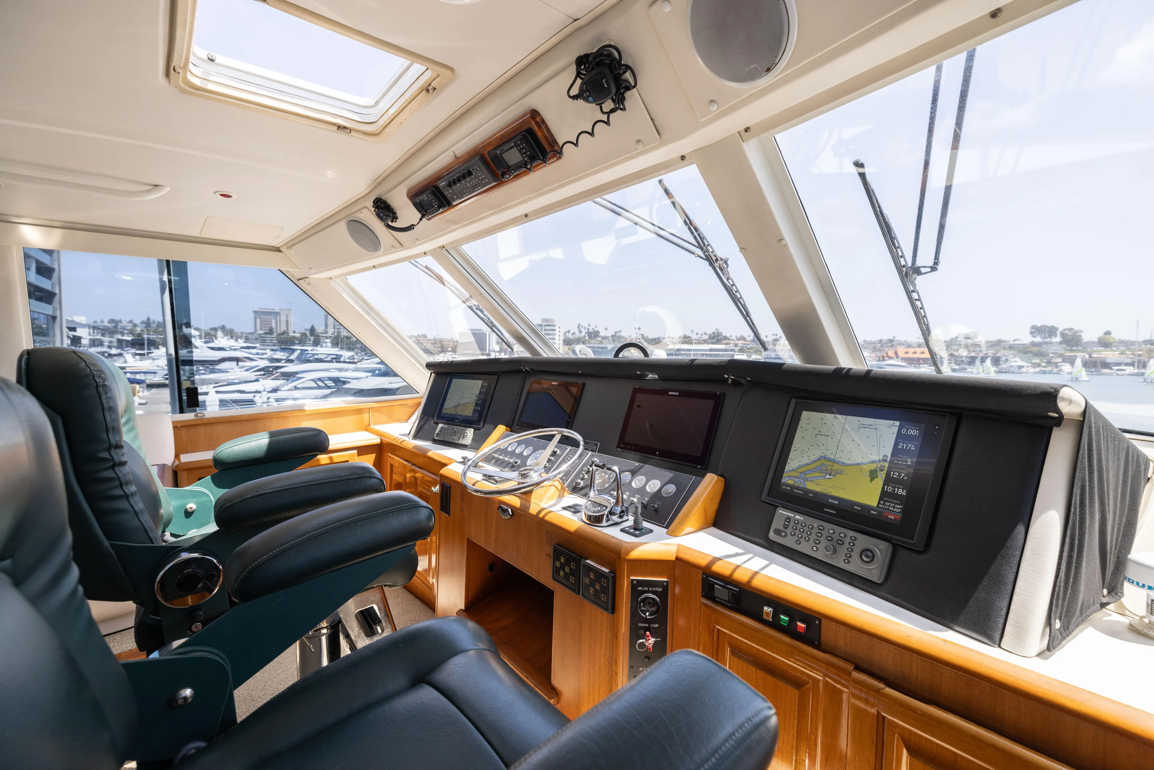 Fan Tail II Yacht Photos Pics Interior of a 1995 Viking Enclosed Bridge yacht with navigation equipment and leather seating.