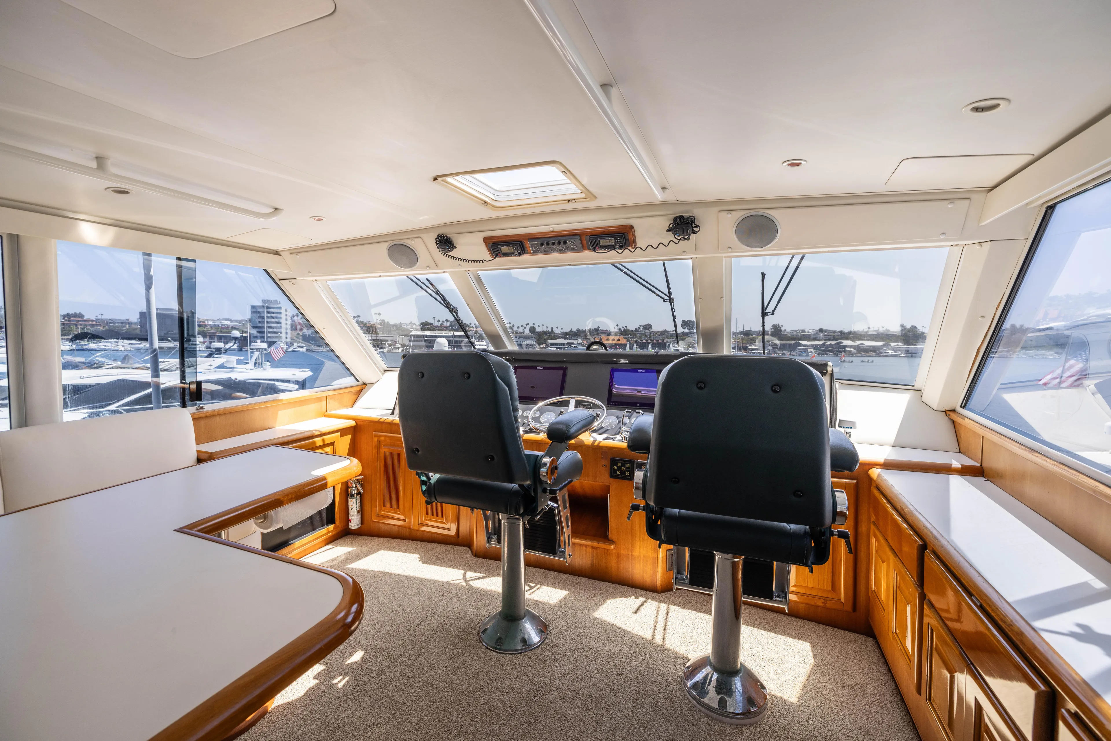 Fan Tail II Yacht Photos Pics Interior of 1995 Viking Enclosed Bridge yacht with helm and seating area.