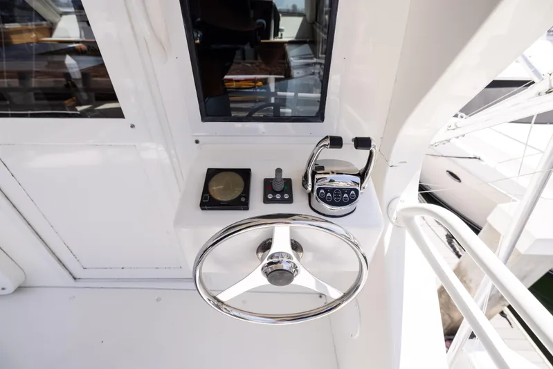 Fan Tail II Yacht Photos Pics 1995 Viking Enclosed Bridge yacht helm with steering wheel and controls.