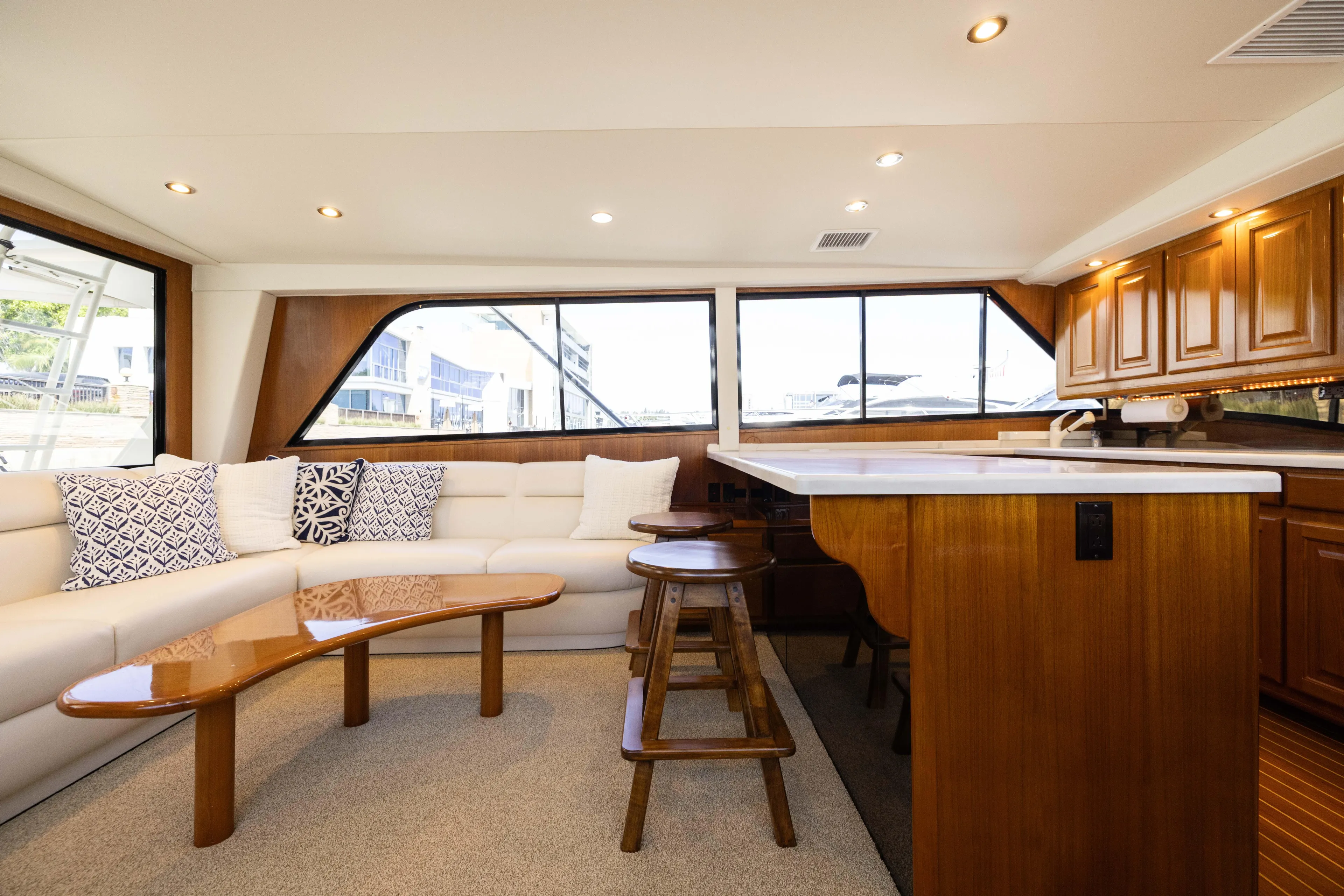 Fan Tail II Yacht Photos Pics Luxurious interior of a 1995 Viking Enclosed Bridge yacht with elegant seating and wooden cabinetry.