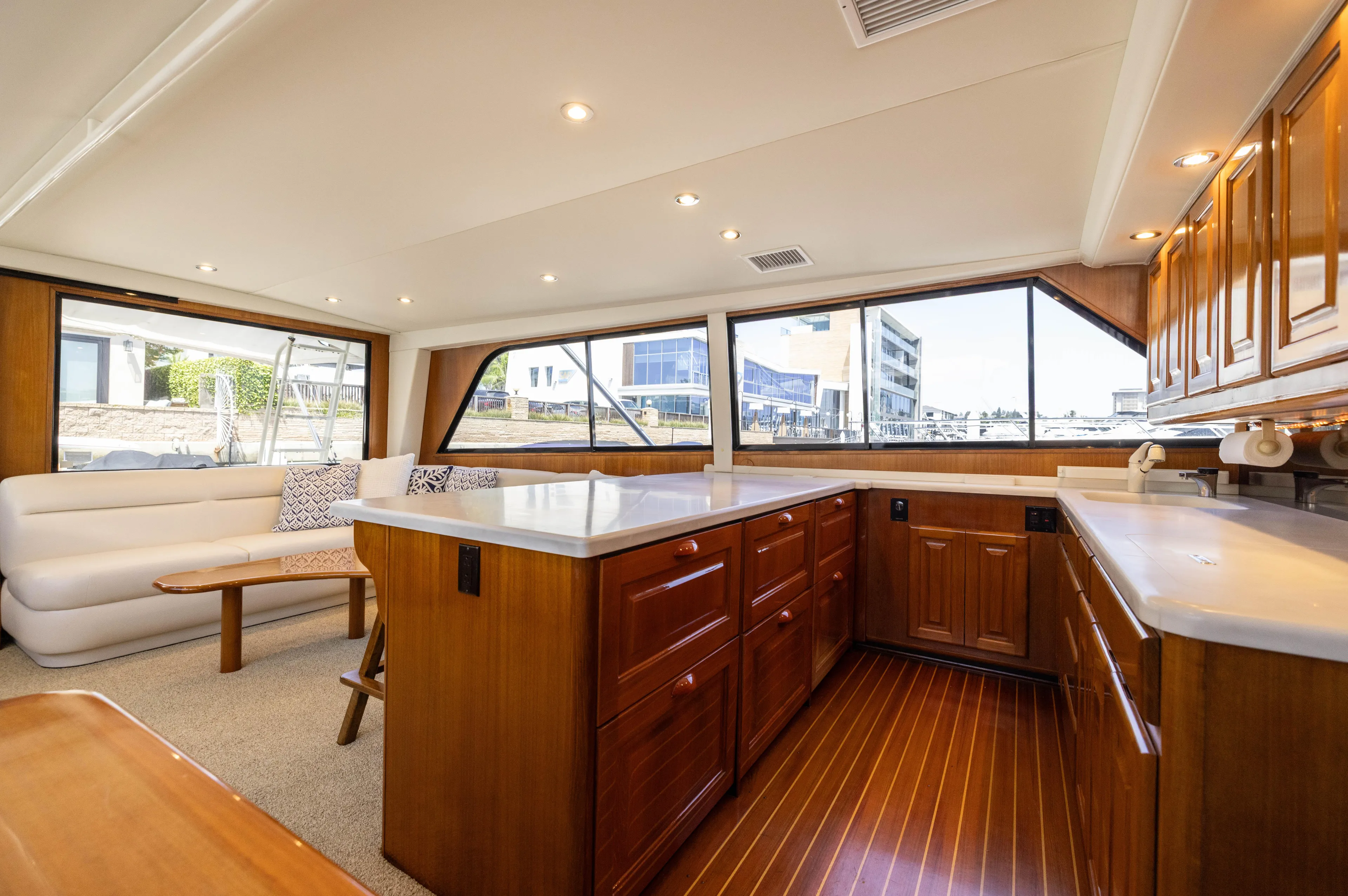 Fan Tail II Yacht Photos Pics Luxurious interior of a 1995 Viking Enclosed Bridge yacht with elegant wood cabinetry and seating.