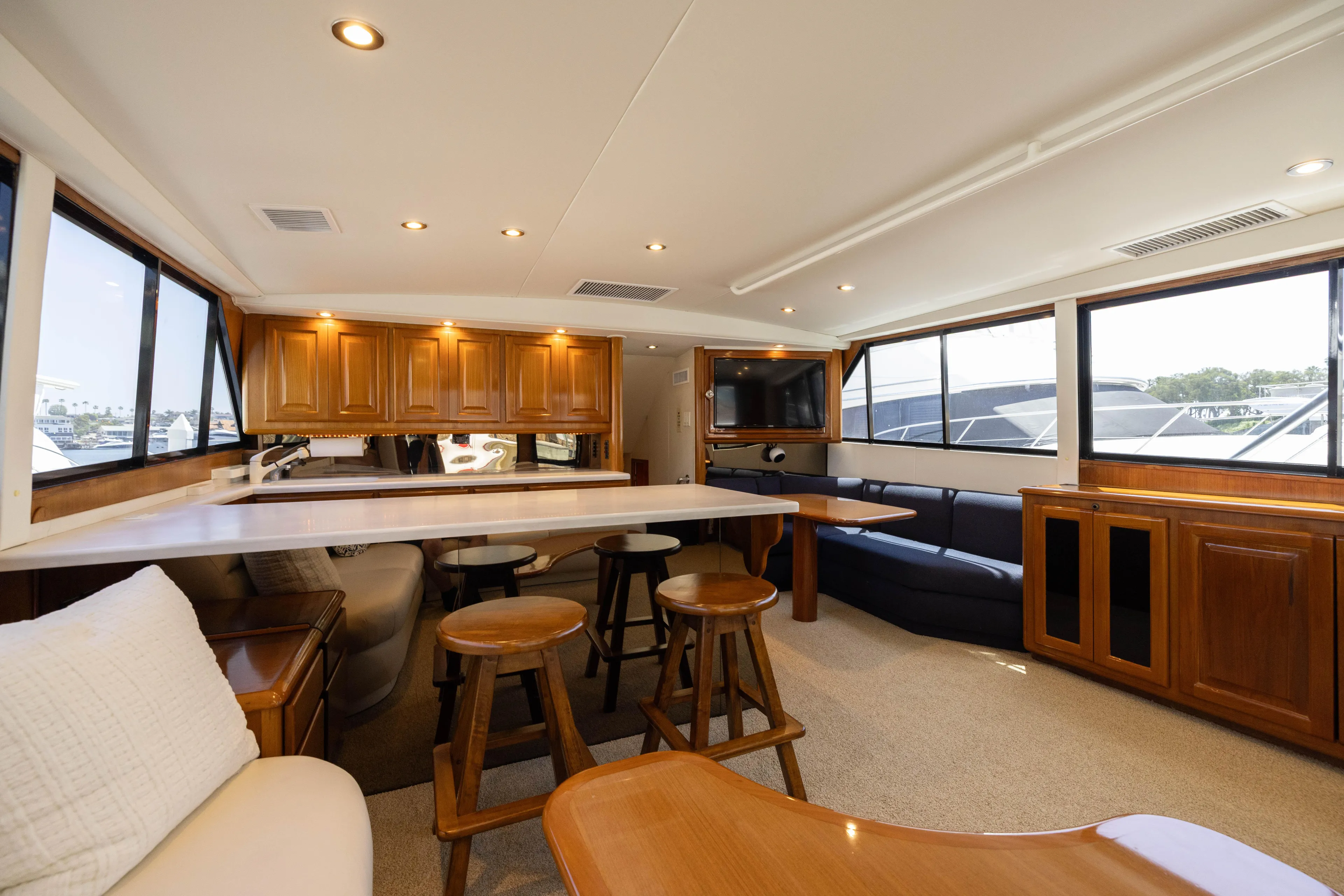 Fan Tail II Yacht Photos Pics Luxurious interior of 1995 Viking Enclosed Bridge yacht with wooden cabinetry and seating.