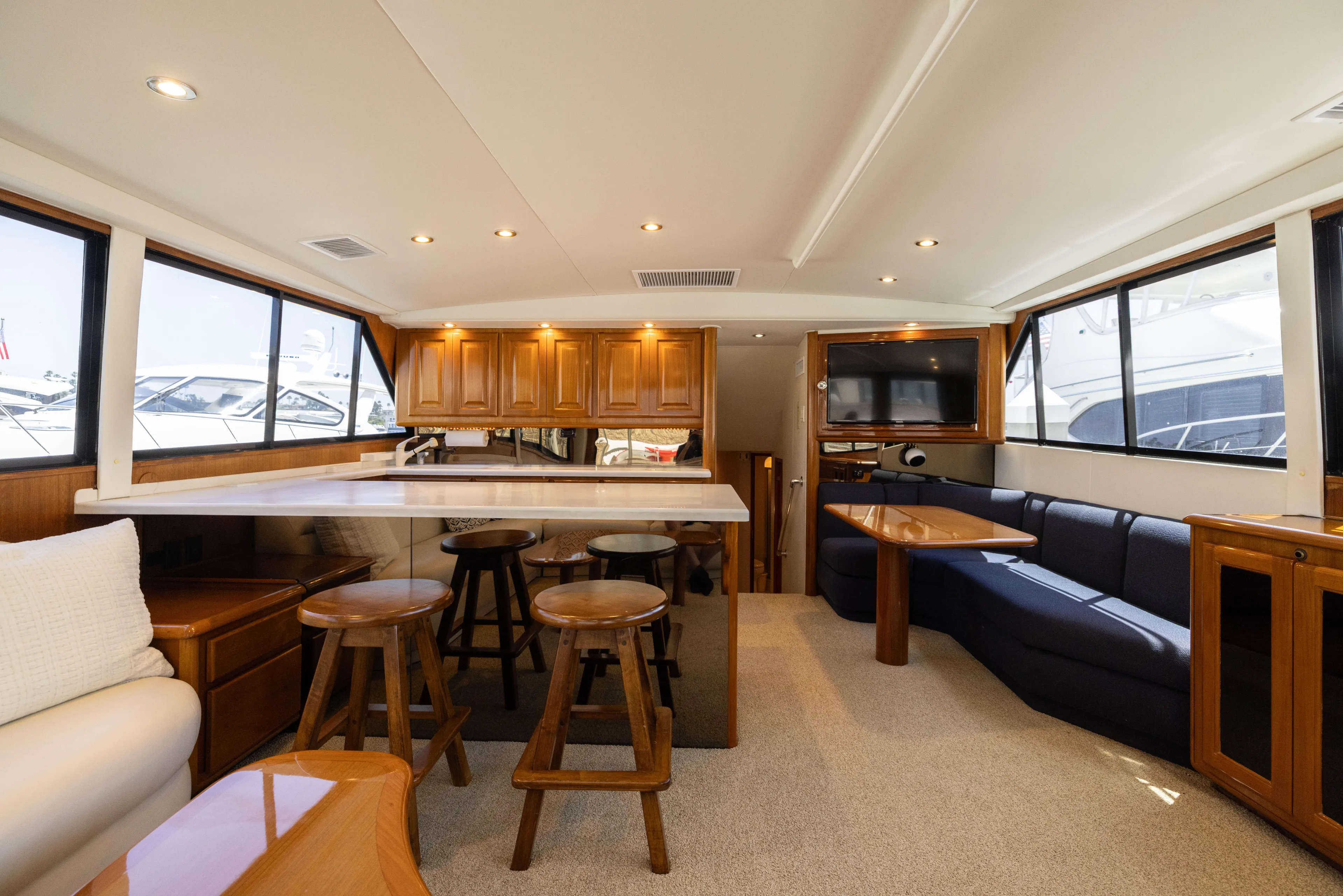 Fan Tail II Yacht Photos Pics Luxurious interior of a 1995 Viking Enclosed Bridge yacht with modern amenities and seating.