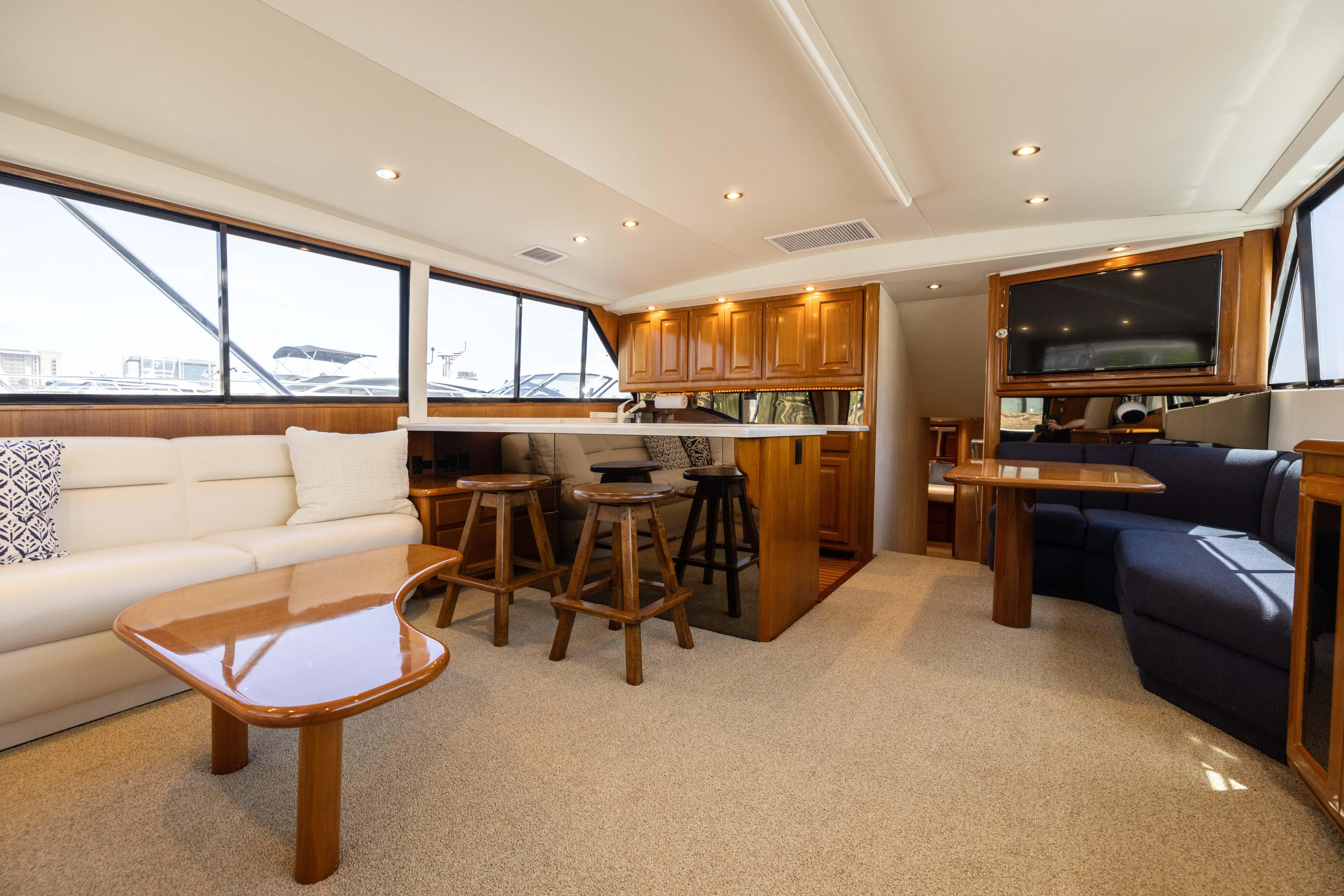 Fan Tail II Yacht Photos Pics Luxurious interior of a 1995 Viking Enclosed Bridge yacht with elegant seating and wooden finishes.