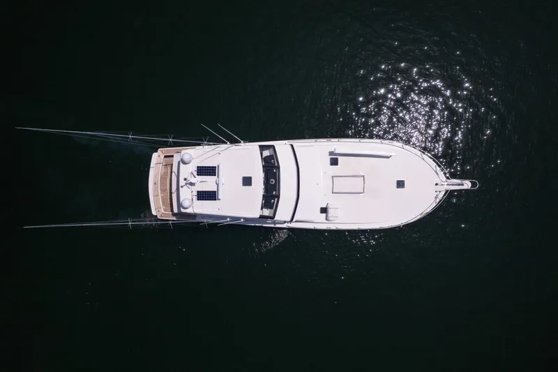 Fan Tail II Yacht Photos Pics Aerial view of 1995 Viking Enclosed Bridge yacht on dark water.