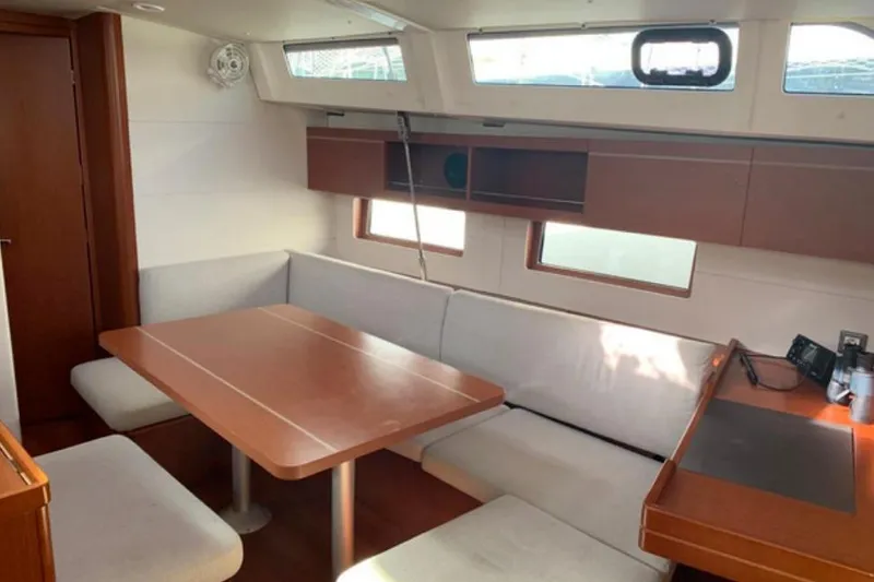  Yacht Photos Pics Interior of 2019 Beneteau Oceanis 46.1 yacht with dining area and seating.