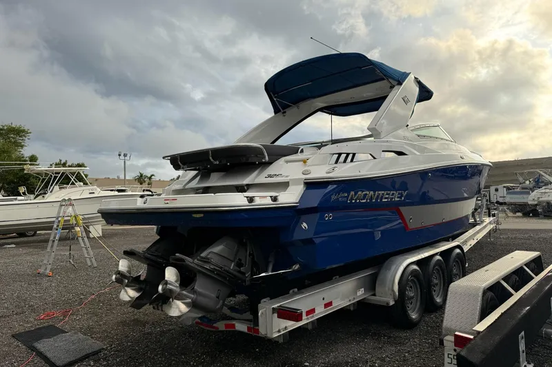  Yacht Photos Pics 2019 Monterey 328SS Super Sport boat on trailer under cloudy sky.
