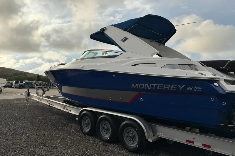 Yacht Photos Pics 2019 Monterey 328SS Super Sport boat on trailer under cloudy sky.