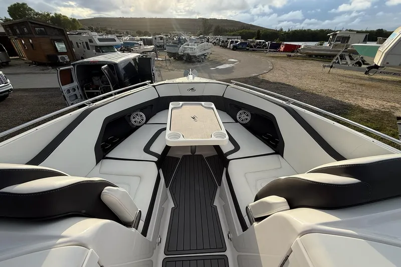  Yacht Photos Pics 2019 Monterey 328SS Super Sport boat interior with seating and table, parked in a marina.