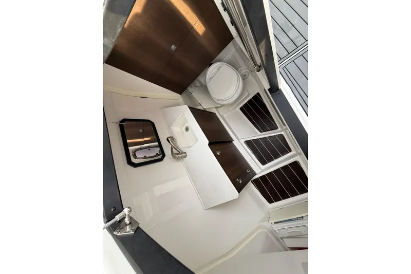  Yacht Photos Pics 2019 Monterey 328SS Super Sport boat interior with sink, toilet, and storage cabinets.