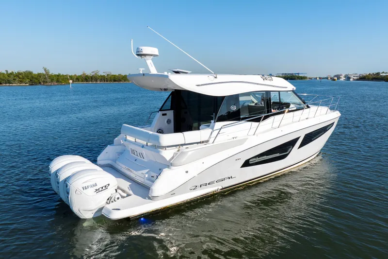 Our Trade Yacht Photos Pics 2024 Regal 42 XO yacht cruising on calm waters under clear blue sky.