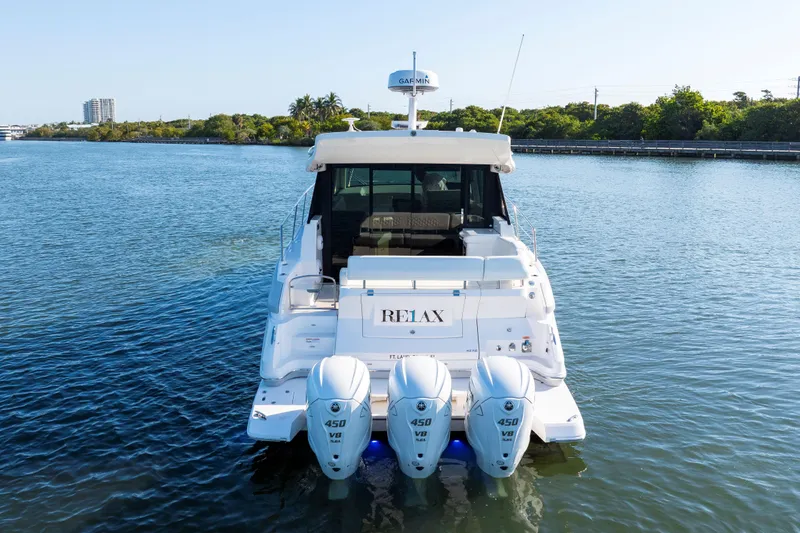 Our Trade Yacht Photos Pics 2024 Regal 42 XO yacht with triple 450 HP engines on calm water.