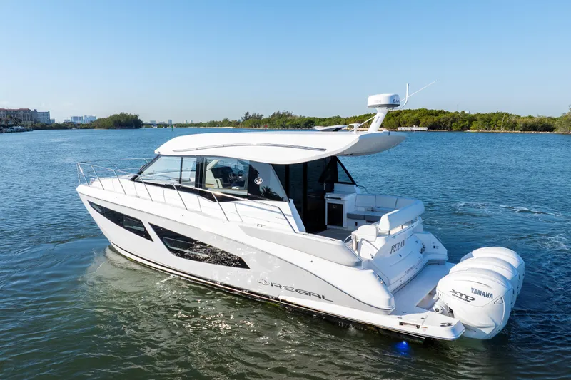 Our Trade Yacht Photos Pics 2024 Regal 42 XO yacht cruising on a serene waterway with Yamaha engines.