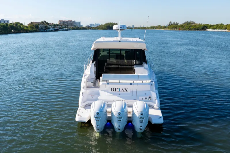 Our Trade Yacht Photos Pics 2024 Regal 42 XO yacht with triple outboard engines on calm water.