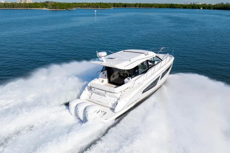 Our Trade Yacht Photos Pics 2024 Regal 42 XO yacht cruising on open water, creating a dynamic wake.