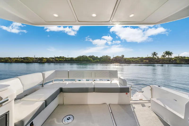 Our Trade Yacht Photos Pics 2024 Regal 42 XO yacht deck with scenic water view and comfortable seating.