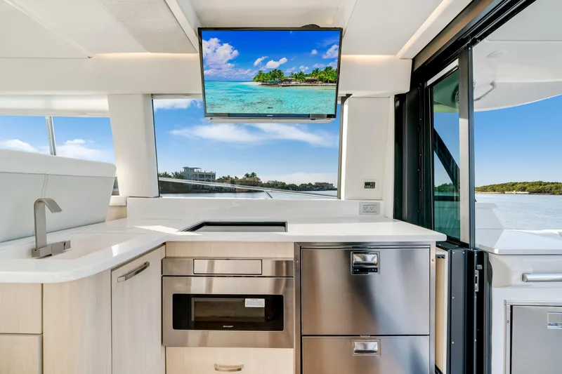 Our Trade Yacht Photos Pics Luxurious interior of 2024 Regal 42 XO yacht with modern kitchen and scenic view.