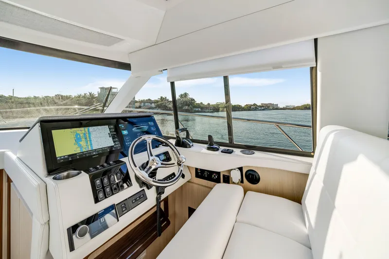 Our Trade Yacht Photos Pics 2024 Regal 42 XO yacht helm with modern navigation system and waterfront view.