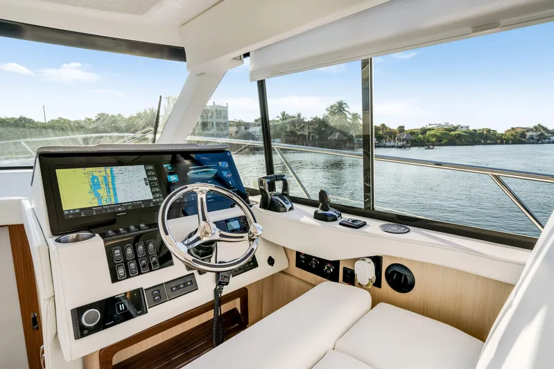 Our Trade Yacht Photos Pics 2024 Regal 42 XO yacht helm with modern navigation system and waterfront view.