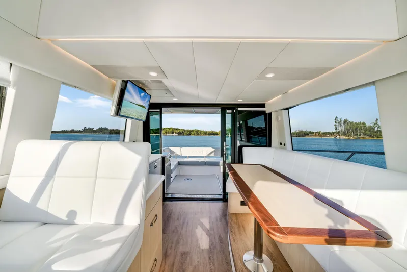 Our Trade Yacht Photos Pics Luxurious interior of 2024 Regal 42 XO yacht with elegant seating and scenic water view.