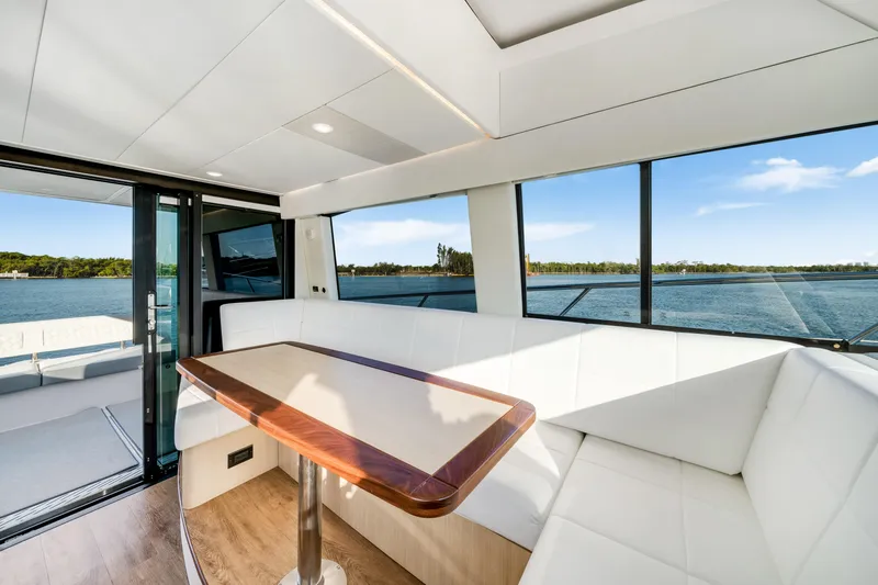 Our Trade Yacht Photos Pics Luxurious interior of 2024 Regal 42 XO yacht with panoramic water views.