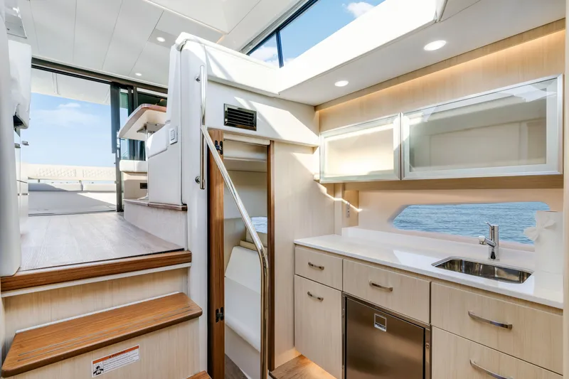 Our Trade Yacht Photos Pics Luxurious interior of 2024 Regal 42 XO yacht with modern kitchen and ocean view.