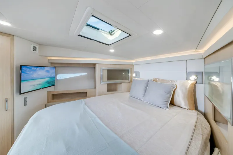 Our Trade Yacht Photos Pics Luxurious cabin interior of 2024 Regal 42 XO yacht with skylight and TV.