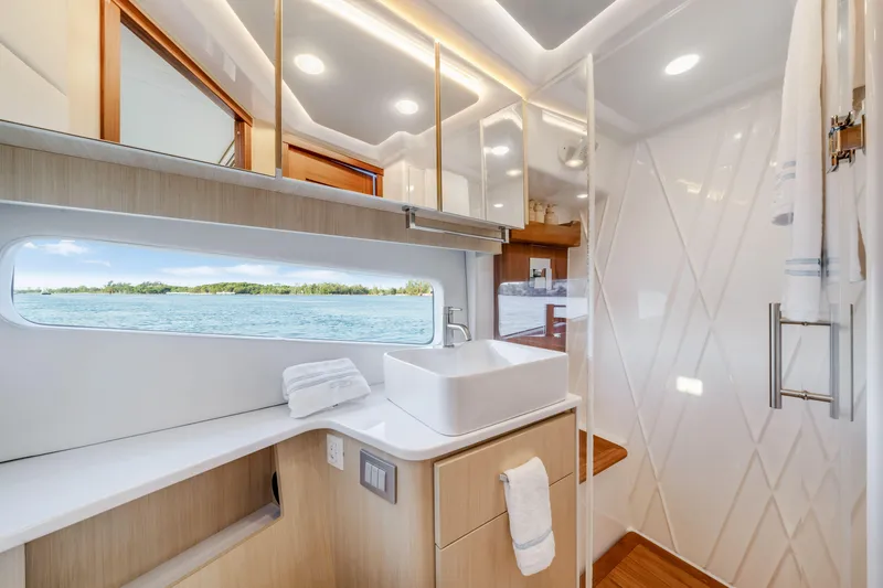 Our Trade Yacht Photos Pics Luxurious bathroom interior of 2024 Regal 42 XO yacht with ocean view.