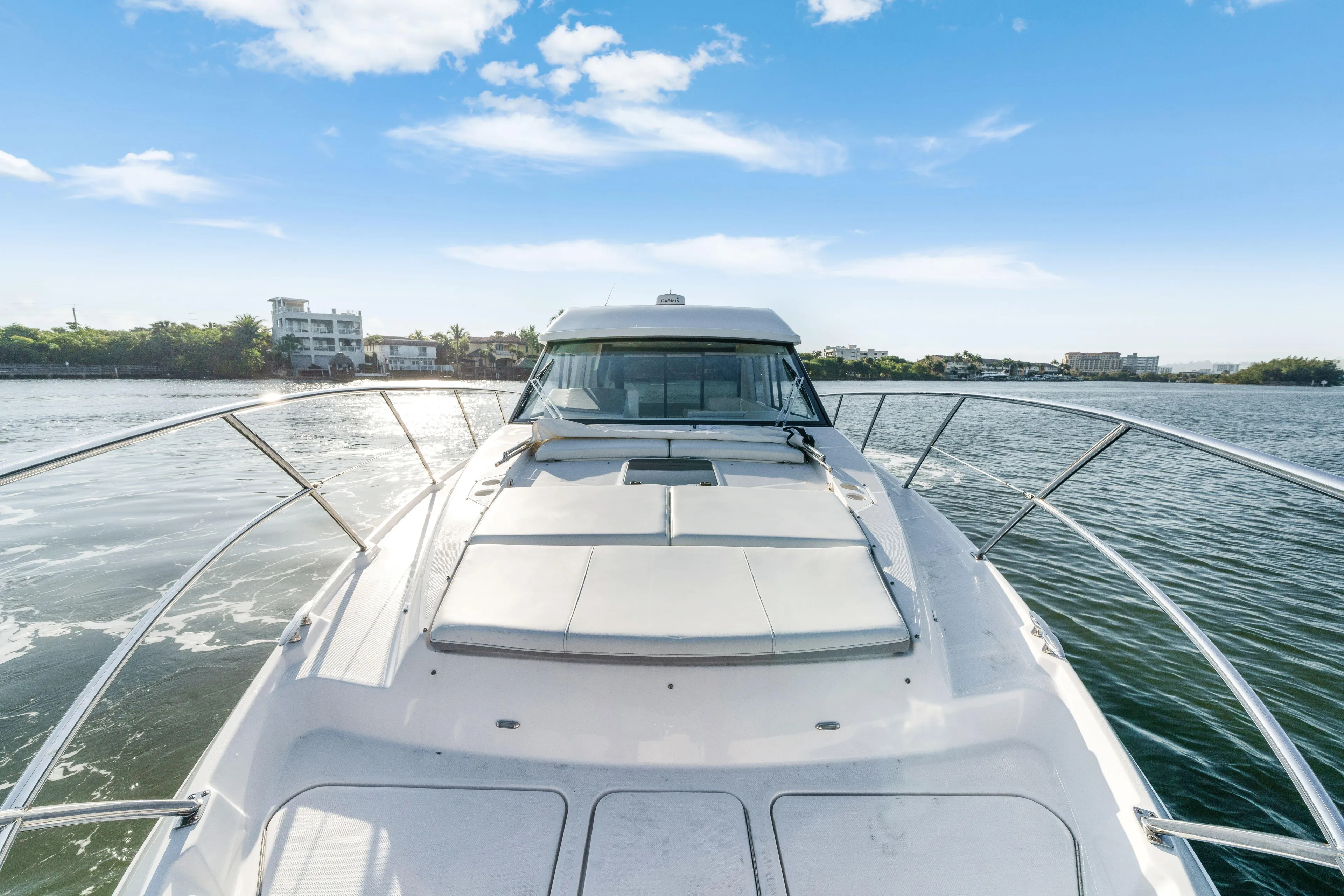 Our Trade Yacht Photos Pics 2024 Regal 42 XO yacht cruising on a sunny day, showcasing sleek design and luxury.