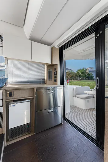 Next Waypoint Yacht Photos Pics Interior of 2020 Prestige 420 Flybridge yacht with modern kitchen and outdoor seating area.