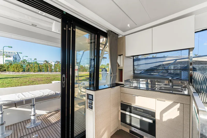 Next Waypoint Yacht Photos Pics Modern kitchen on 2020 Prestige 420 Flybridge yacht with sleek design and outdoor view.